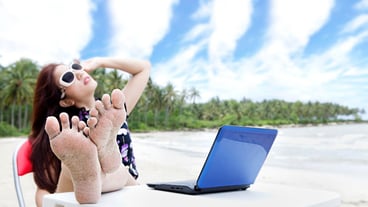 Woman relaxing with laptop outdoor