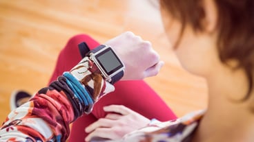 Slim woman looking at her smartwatch