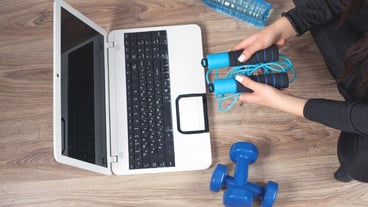 Girl doing sports at home. Watching online training