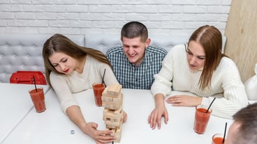 Friends gathered at the café to play a game of jenga.