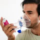 Asian young man from india using a respiratory inhaler Study shot on white background selective focus
