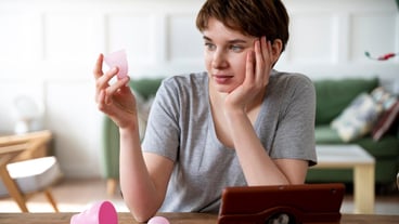 Medium shot woman looking at menstrual cup