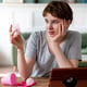 Medium shot woman looking at menstrual cup