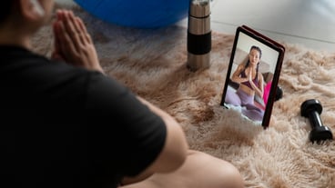 Woman following online fitness instructor