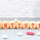 Medicine concept An arrow of pills points to a sign that says DENTISTRY