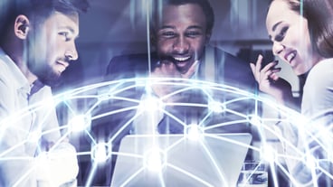 Three business partners are sitting at a table with a laptop and brainstorming trying to find the best strategy. Network hologram. Toned image