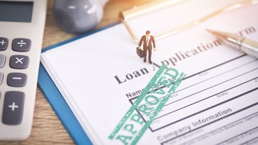 Loan application form with Rubber stamping that says Loan Approved, Financial loan approval