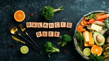 Balanced diet inscription Avocado carrot orange broccoli dried fruits nuts and parsley Top view Free space for your text