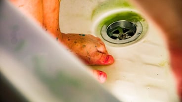 Close-up of dirty feet in bathroom