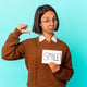 Young hispanic woman holding a smile note feels proud and self confident, example to follow