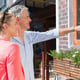 Happy senior couple shopping and pointing in the city