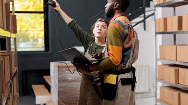 Stockroom manager scanning packages barcode