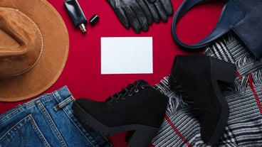 Women's fashion clothing and accessories and blank paper.