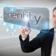 Businessman pointing to word identity against technology interface