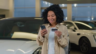 African American happy customer happy woman shopper has credit card cell phone cell phone shopping new luxury shopping
