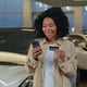 African American happy customer happy woman shopper has credit card cell phone cell phone shopping new luxury shopping