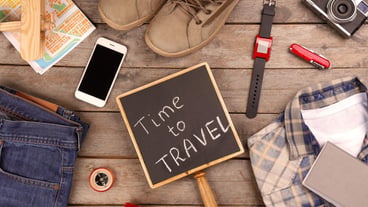 Travel accessories on wooden background