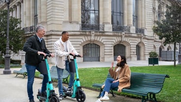 Adults learning to use electric scooter