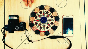 High angle view of camera and cellphone on carom board
