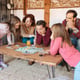Happy family at home in the couch playing classic table games