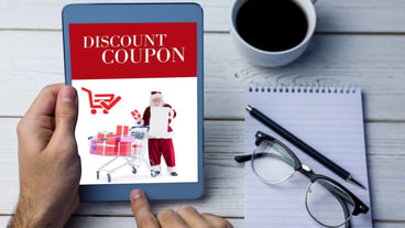 Cropped image of person using tablet computer against sale advertisement