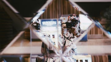 Reflection of woman photographing with camera