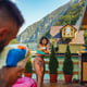 Couple having a water fight with squirt guns