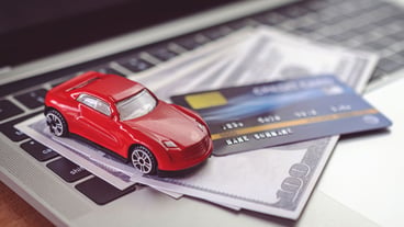 Credit card and money on laptop