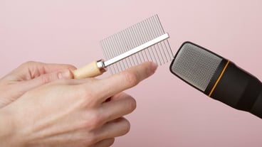 Person using comb close to microphone for asmr