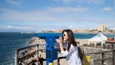 Pretty long hair brunette girl relaxing near ocean.
