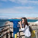 Pretty long hair brunette girl relaxing near ocean.