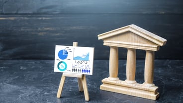 Bank or government building and statistics easel Evaluation of efficiency performance indicators Taxes Financial stability and solvency of the bank State debt Budget analytics Data collection