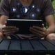 Person Using Tablet in Nature with Security and Network Icons