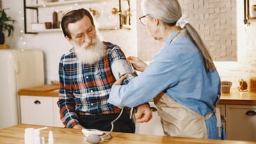 Old couple in a kitchen.