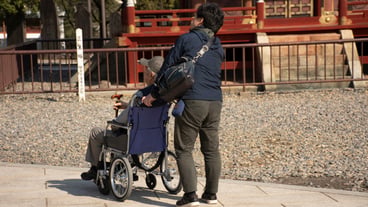 Japanese family people push wheelchair and bring oldman father walking visit and praying in Naritasan Shinshoji Temple at Chiba Prefecture on March 31 2019 in Tokyo Japan