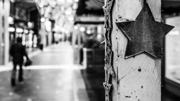 Close-up of chain hanging on footpath in city