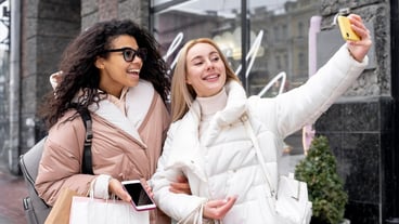 Medium shot smiley women taking selfie
