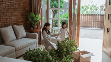 Happy Asian mother and daughter decorating the Christmas tree