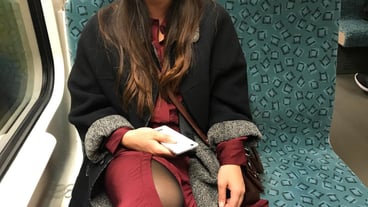 Midsection of woman sitting at train