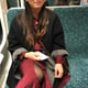 Midsection of woman sitting at train