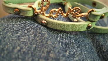 Close-up of text on green belt over blue fabric