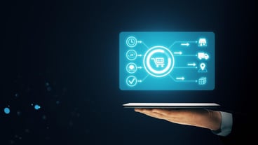 Hand holding a tablet with a glowing virtual shopping interface on a dark background