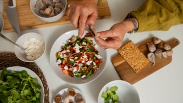 Senior woman making dish with figs in the kitchen