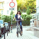 Pretty young woman riding bike outdoors