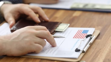 Male hands in suit lie on application for usa visa