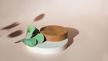 Empty wooden podium beige background Product presentation with flowers and leaves