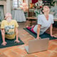 Full length of mother and daughter sitting on floor at home
