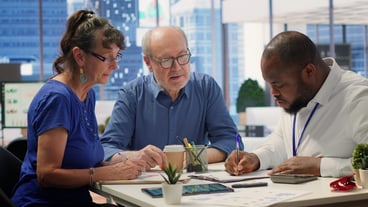 Financial planner helping senior couple with various retirement strategy
