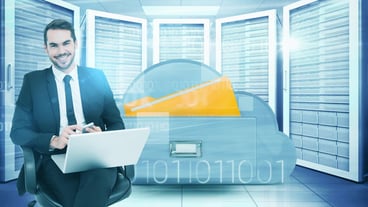 Happy businessman with laptop using smartphone against composite image of cloud computing drawer
