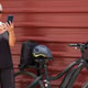 Smiling elderly cyclist on urban city tour with mobile phone enjoying healthy lifestyle
